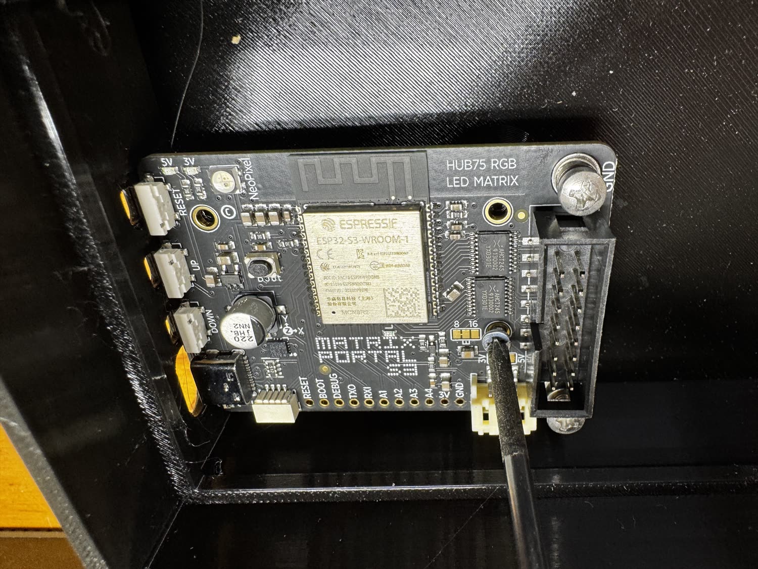 Screwing the board onto the case standoffs