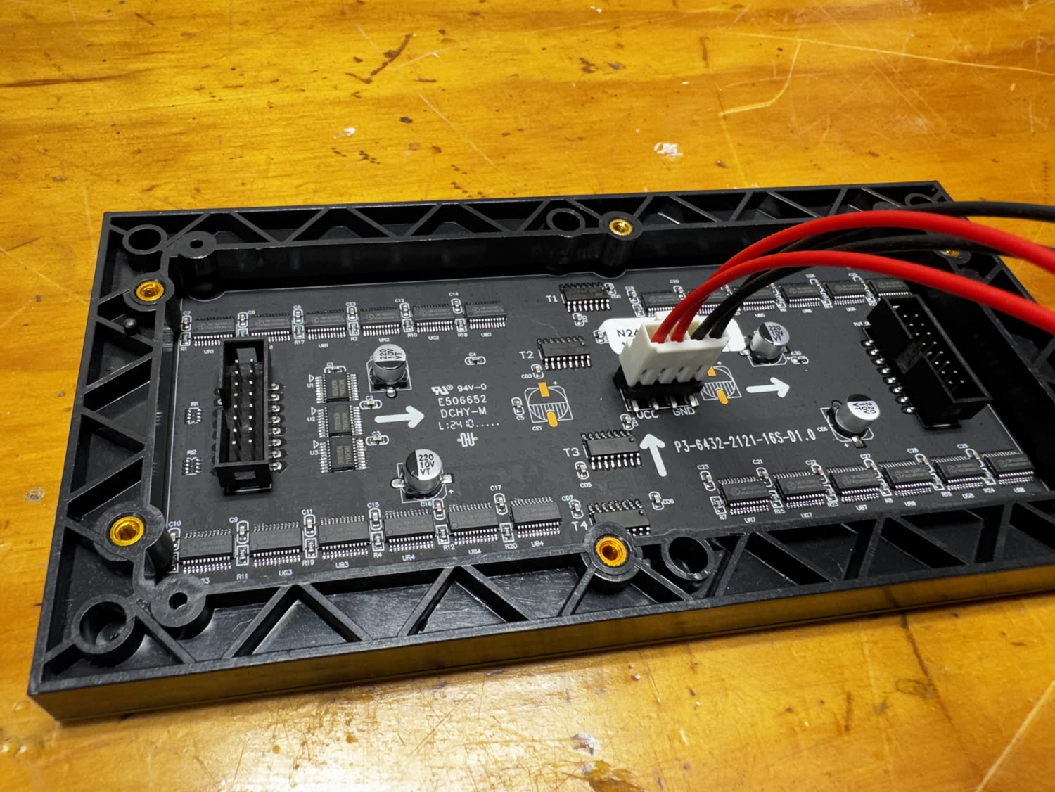 The back of the LED panel with the ribbon and power connectors attached
