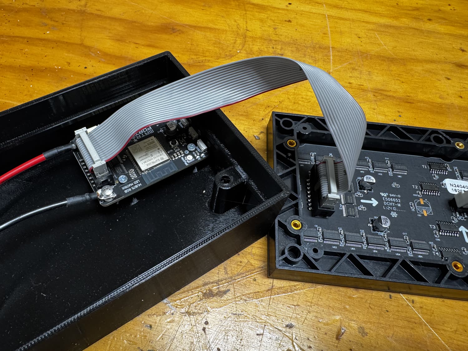 The two halves connected by ribbon cable