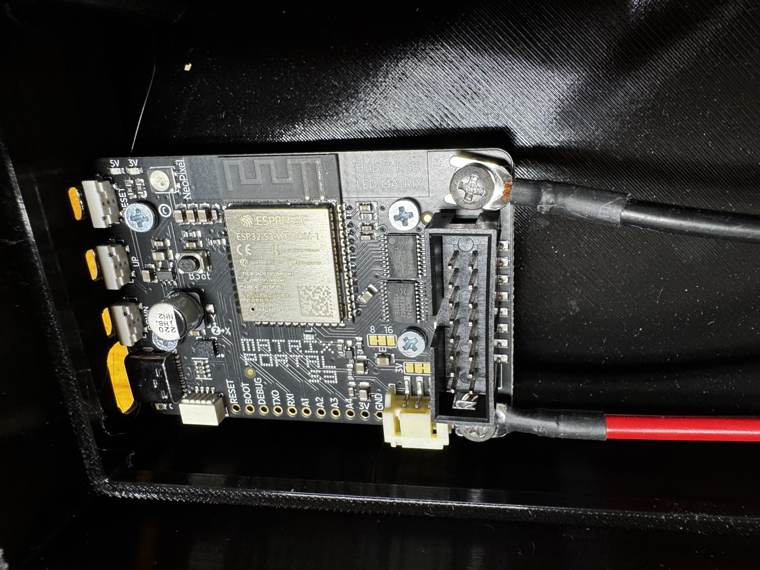 Ribbon cable and red/black power leads connected to the mounted board