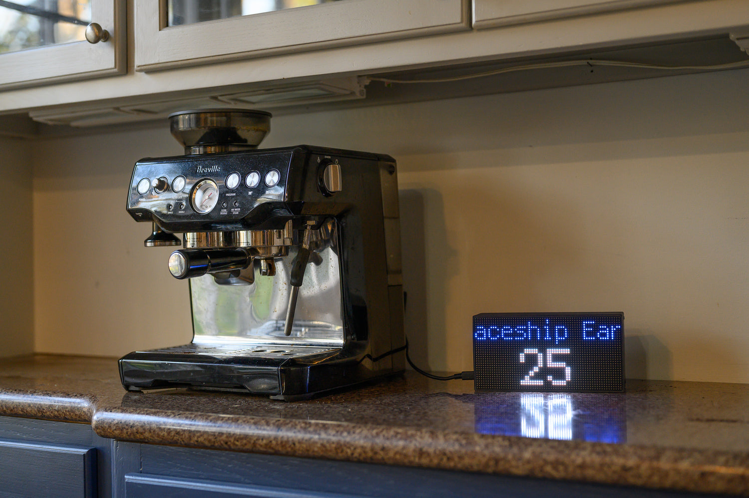 The display beside an espresso machine showing a ride wait time